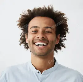 Happy young man with curly hair smiling brightly.